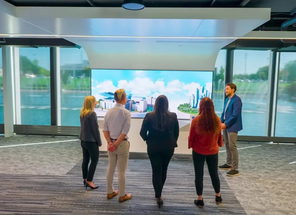 Visitors to the Johnson Controls customer experience center engaged with an AV exhibit.-1