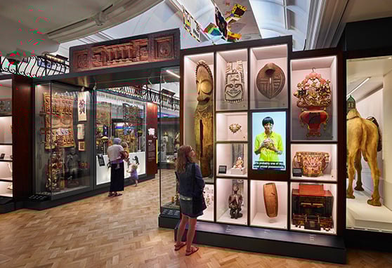 Visitors view a display of cultural objects from around the world at the Horniman Museum World Gallery in London.
