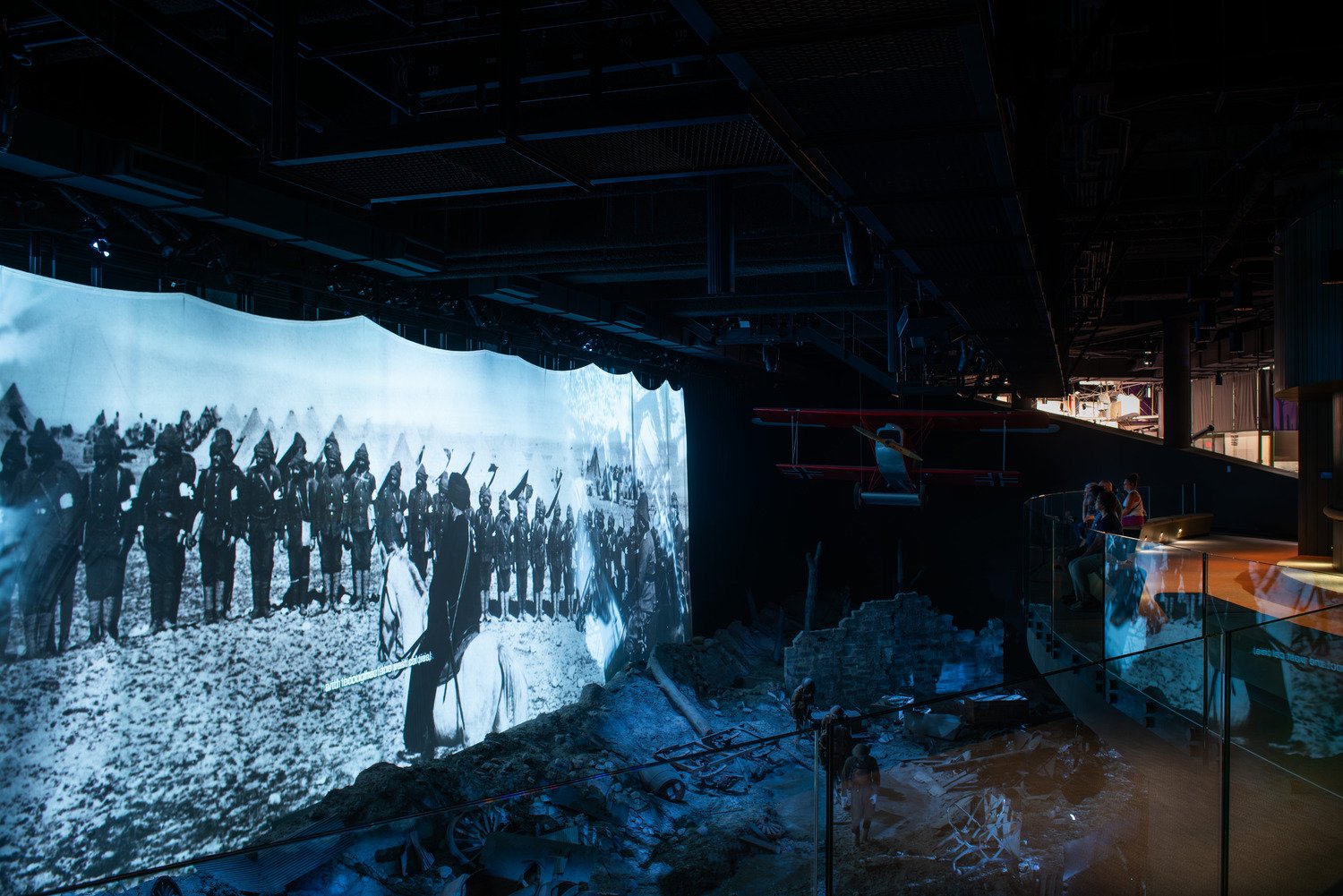 Battlescapes exhibit with a large media display and a soldier diorama in the front.