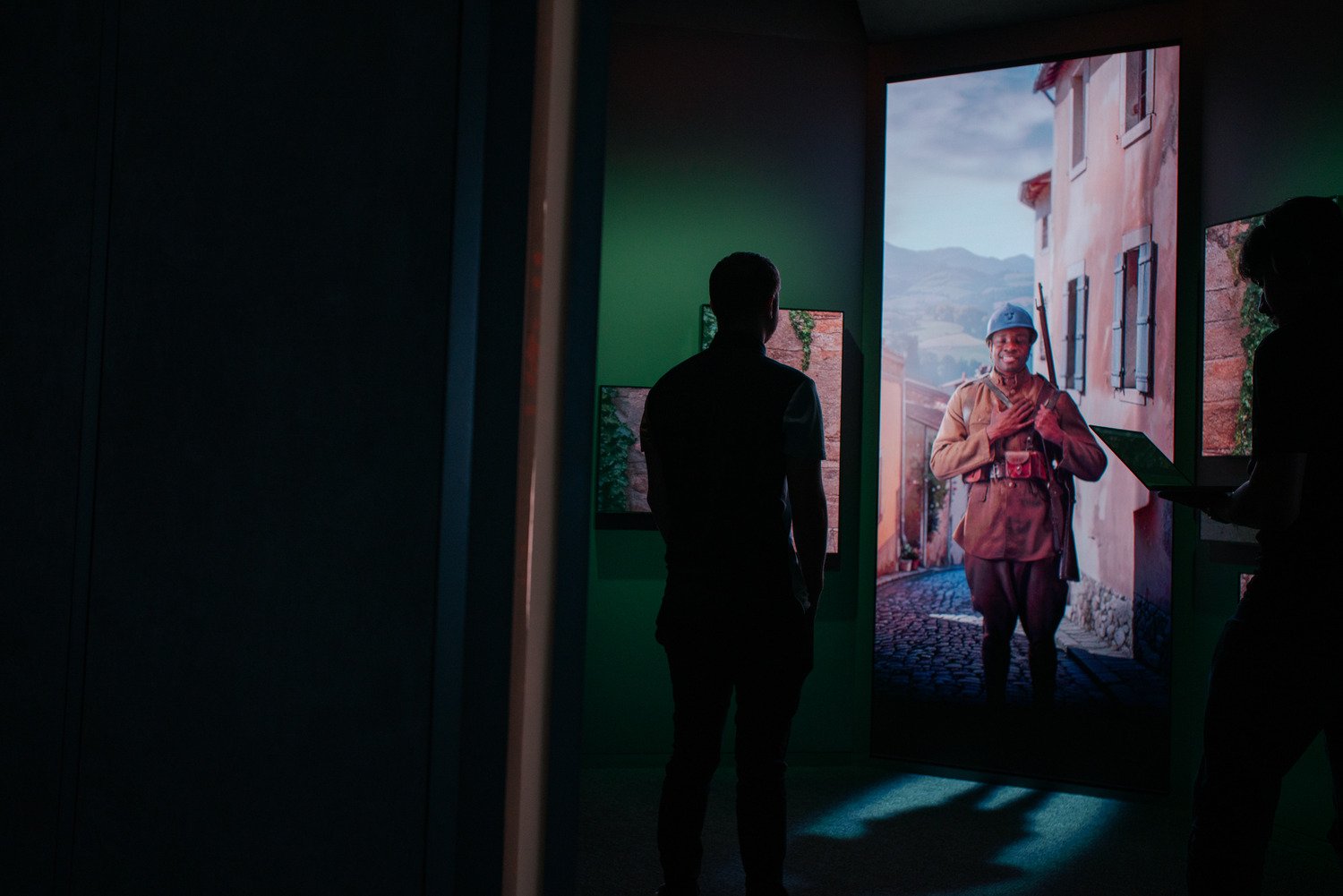 A man standing in front of a character on the LED wall.