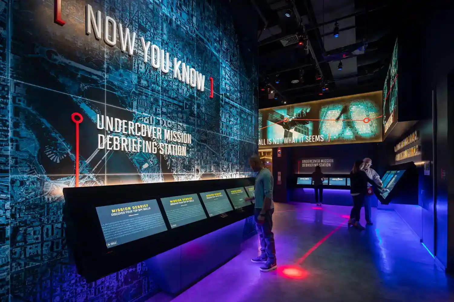 People interacting with technology at the International Spy Museums