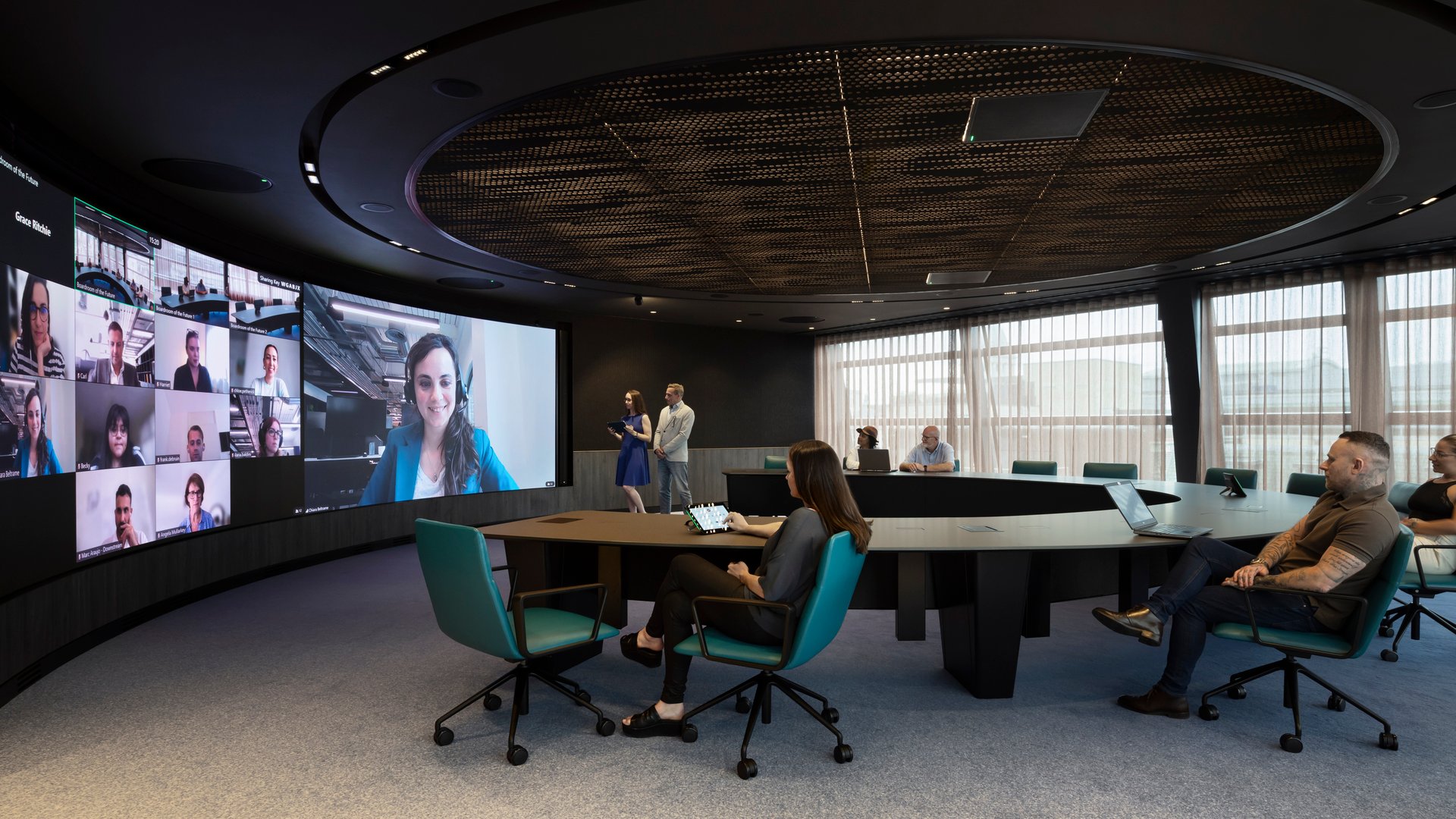 A group of people sitting around a table in a board room 