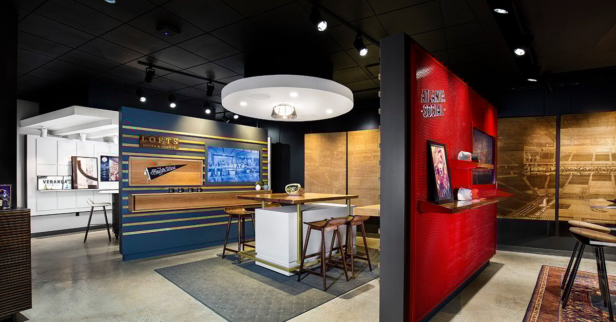 A modern and stylish sales center for the Atlanta Hawks. The space features sleek design elements such as clean lines, contemporary lighting, and a combination of wood, metal and vivid accent colors.