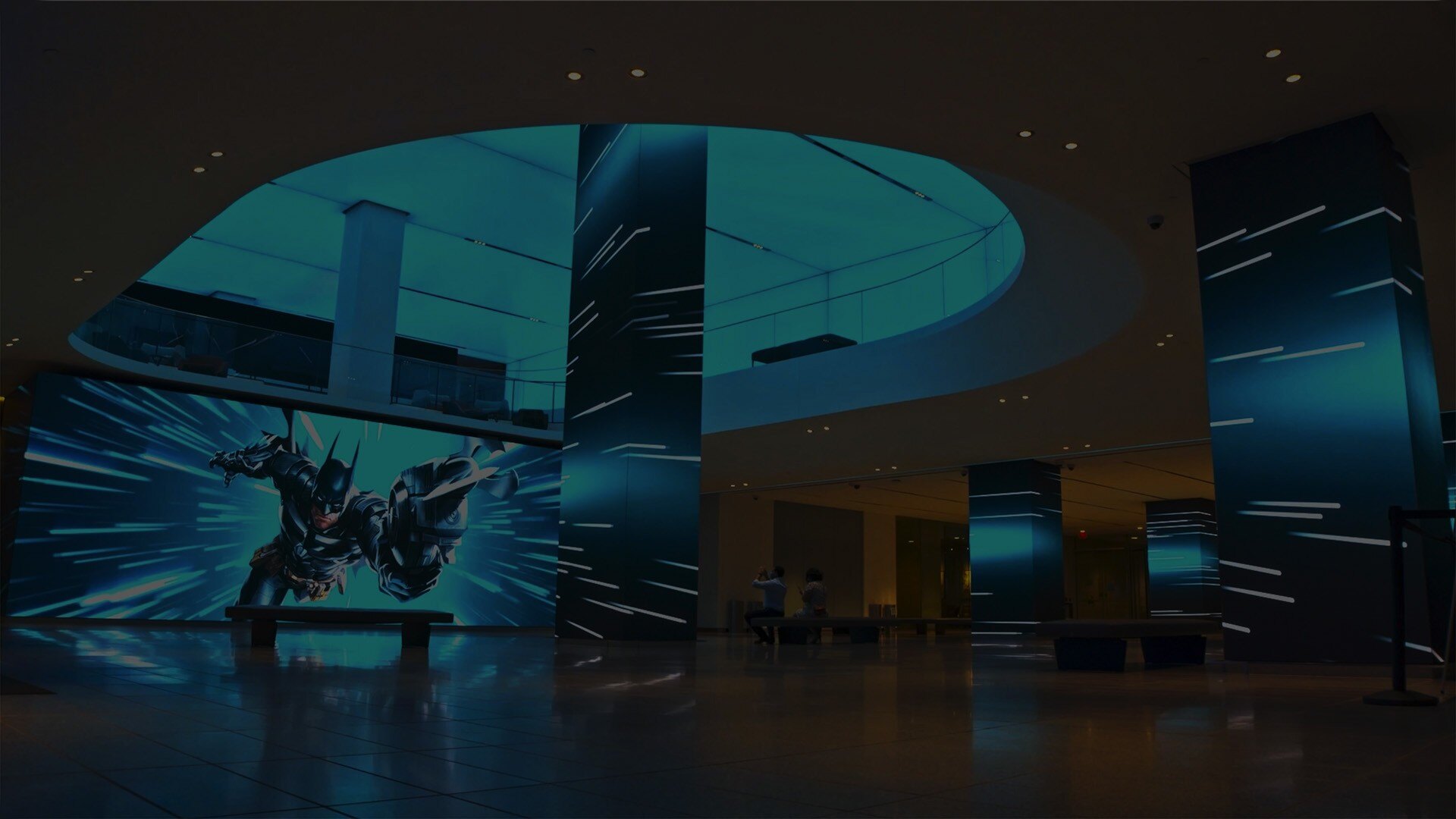 The AT&T Headquarters lobby features an expansive, modern space filled with vibrant video wall activations displaying dynamic digital content. Multiple large screens create an immersive visual experience that showcases brand storytelling and cutting-edge technology.