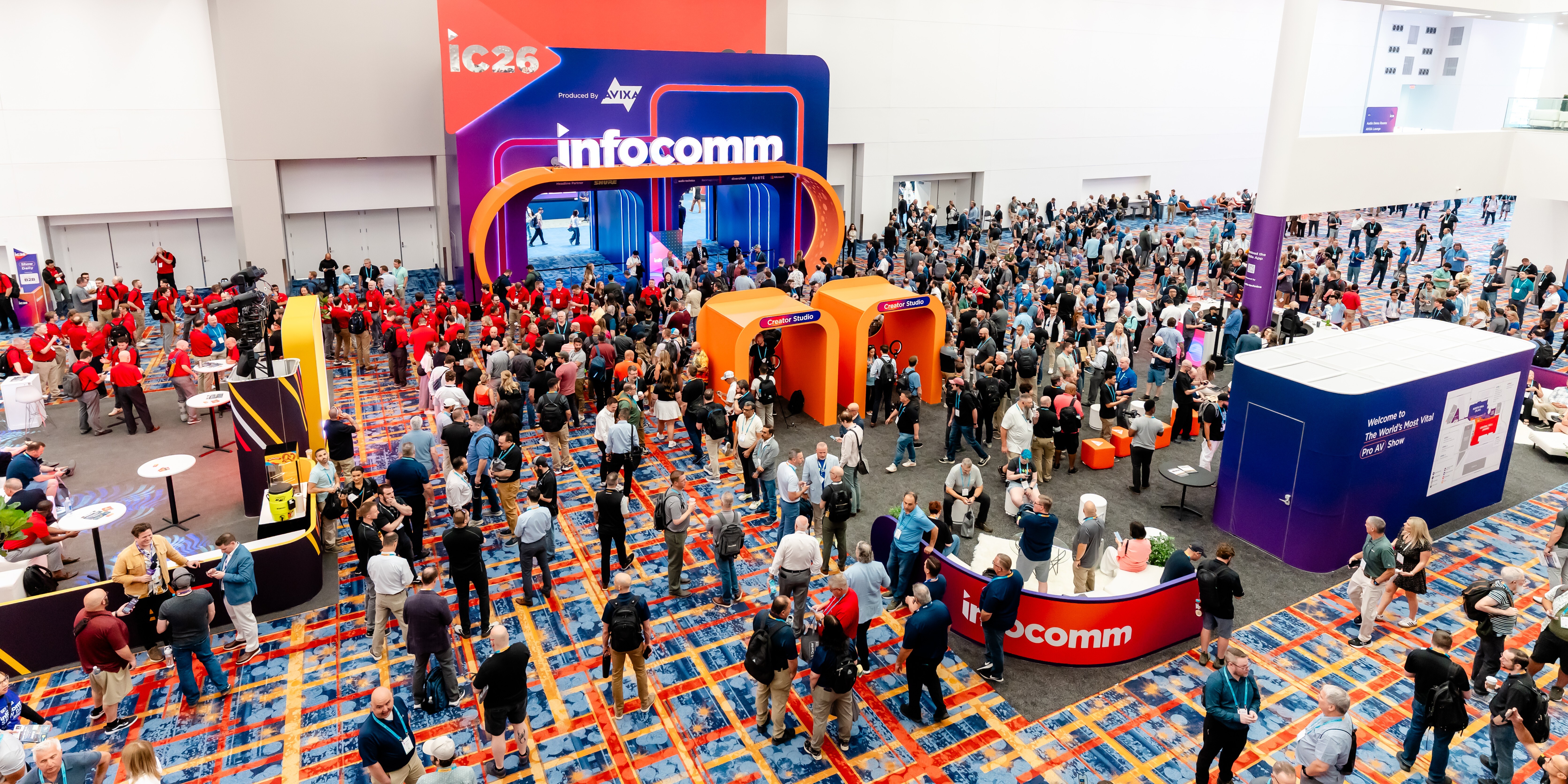 Crowds of people walking around the entrance of InfoComm